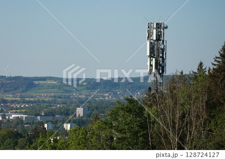 A tall tower with a lot of antennas on top of it 128724127