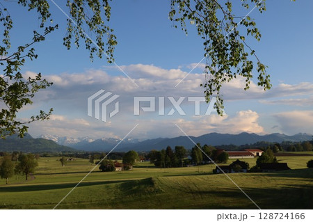 Beautiful countryside scene with a blue sky and mountains in the background 128724166