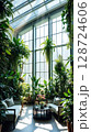 Lush indoor garden with natural light and cozy seating in a serene environment 128724606