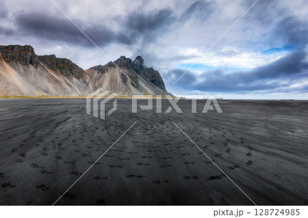 Amazing nasty day and dramatic black sand beach on Stokksnes cape in Iceland Amazing nasty day and dramatic black sand beach on Stokksnes cape in Iceland 128724985