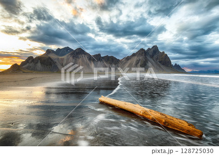 Amazing sunset and dramatic black sand beach on Stokksnes cape in Iceland 128725030
