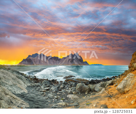 Amazing sunset and dramatic black sand beach on Stokksnes cape in Iceland 128725031