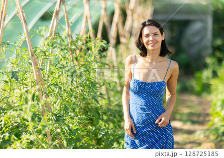 Adult woman posing in garden greenhouse 128725185