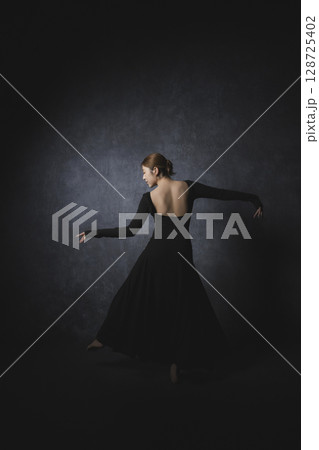黒背景でポーズをとる女性　　 128725402