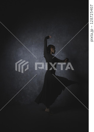 黒背景でポーズをとる女性　　 128725407