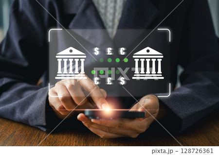 A person using a smartphone for secure online banking, featuring a digital interface symbolizing modern financial transactions. 128726361
