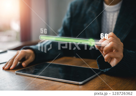 Visual representation of 6G technology advancement with a digital progress bar on a tablet, symbolizing future connectivity. Visual representation of 6G technology advancement with a digital progress bar on a tablet, symbolizing future connectivity. 128726362