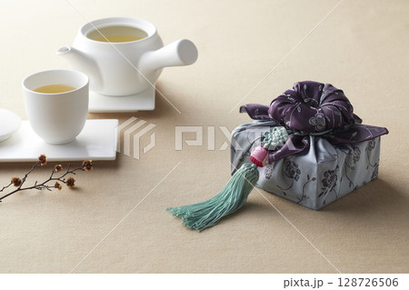 Elegant Korean table setting with traditional Korean bojagi gift wrapping for Chuseok, ceramic vase and fabric, tree branches. Elegant Korean table setting with traditional Korean bojagi gift wrapping for Chuseok, ceramic vase and fabric, tree branches. 128726506
