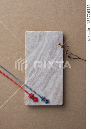 Elegant Korean table setting with traditional Korean bojagi gift wrapping for Chuseok, ceramic vase and fabric, tree branches. 128726536