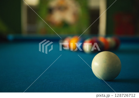 A player prepares to break on a neatly arranged pool table A player prepares to break on a neatly arranged pool table 128726712