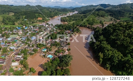 Aerial view of Karen Ruammit Elephant Camp village in Chiang Rai province of Thailand flooded after Kok river rising. Aerial view of Karen Ruammit Elephant Camp village in Chiang Rai province of Thailand flooded after Kok river rising. 128727248