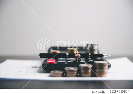 Financial calculate accountant blur background close up on calculator with graph chart banner bank office desk. Finance Concept tax banking money expense accounting budget businessman use calculator. Financial calculate accountant blur background close up on calculator with graph chart banner bank office desk. Finance Concept tax banking money expense accounting budget businessman use calculator. 128728464
