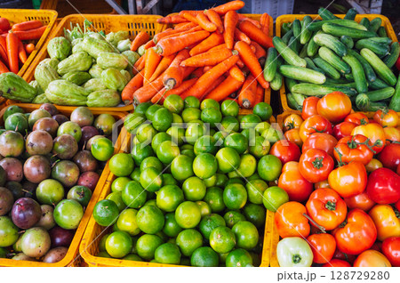 assortment of fresh vegetables on the counter at grocery farmers market in Vietnam in Asia assortment of fresh vegetables on the counter at grocery farmers market in Vietnam in Asia 128729280