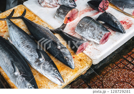 catch of fresh mackerel fish. Chilled whole and cut king mackerel on the counter at Asian seafood market in Vietnam catch of fresh mackerel fish. Chilled whole and cut king mackerel on the counter at Asian seafood market in Vietnam 128729281