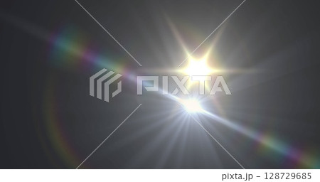 Radiating lens flare artifacts creating rainbow streak and circular halos in dark studio backdrop Radiating lens flare artifacts creating rainbow streak and circular halos in dark studio backdrop 128729685