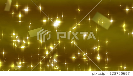 Image of falling golden confetti over gold background 128730697