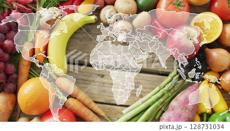 Image of world map over fruits and vegetable lying on table 128731034