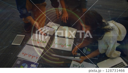 Image of round scanner and diverse colleagues discussing over documents at office Image of round scanner and diverse colleagues discussing over documents at office 128731466