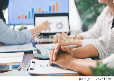 Financial business team in office, financial expert analyze business report graph and finance chart at corporate office. Concept of finance economy, banking business and stock market research. 128731776
