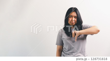 Asian girl expresses dislike, person express negative feeling, concept business complaint from customer ensuring employee satisfaction negative feedback to prevent mental strain customer dislike Asian girl expresses dislike, person express negative feeling, concept business complaint from customer ensuring employee satisfaction negative feedback to prevent mental strain customer dislike 128731818