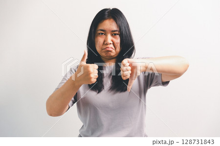 Asian girl expresses dislike, person express negative feeling, concept business complaint from customer ensuring employee satisfaction negative feedback to prevent mental strain customer dislike Asian girl expresses dislike, person express negative feeling, concept business complaint from customer ensuring employee satisfaction negative feedback to prevent mental strain customer dislike 128731843