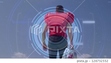 Standing athlete in red football jersey holding helmet by side at open field, with HUD overlay Standing athlete in red football jersey holding helmet by side at open field, with HUD overlay 128732332
