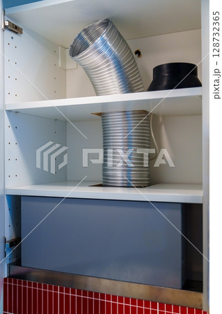 Kitchen Ventilation System Installation Inside Cabinet with Shelves and Ductwork Kitchen Ventilation System Installation Inside Cabinet with Shelves and Ductwork 128732365