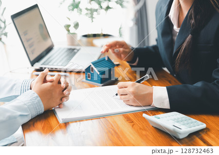 Home loan officer uses calculator with house plan loan real estate or property. important to loan calculator seek real estate, finance insurance advice ensure smart financial decisions for business. Home loan officer uses calculator with house plan loan real estate or property. important to loan calculator seek real estate, finance insurance advice ensure smart financial decisions for business. 128732463