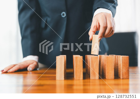 Business risk control concept, Businesswoman protect wooden block fall to planning and strategy in risk to business alternative and prevent. investment insurance business. Business risk control concept, Businesswoman protect wooden block fall to planning and strategy in risk to business alternative and prevent. investment insurance business. 128732551