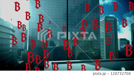 Image of falling bitcoin sings over cityscape 128732708