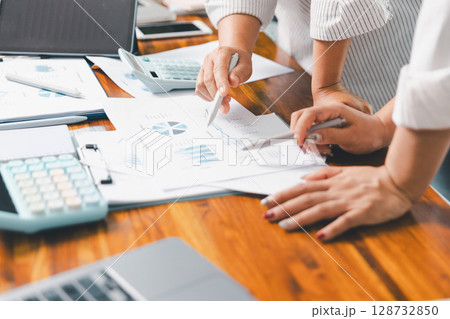 Financial business team in office, financial expert analyze business report graph and finance chart at corporate office. Concept of finance economy, banking business and stock market research. Financial business team in office, financial expert analyze business report graph and finance chart at corporate office. Concept of finance economy, banking business and stock market research. 128732850