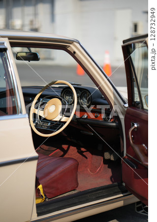 Vintage Classic car steering wheel, with chrome and leather textures in sharp detail, showcases the quality and precision of automotive craftsmanship under natural light. 128732949