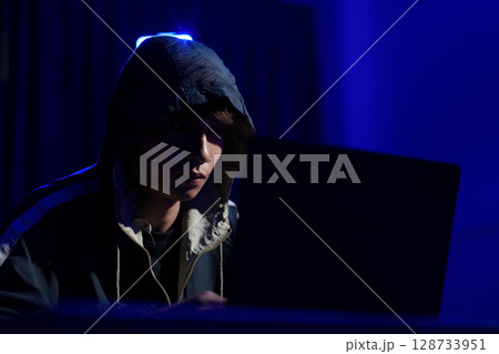 Hacker cyberattack representing data breach and cybersecurity threat in digital system 128733951