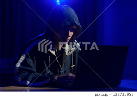 Hacker cyberattack representing data breach and cybersecurity threat in digital system 128733955