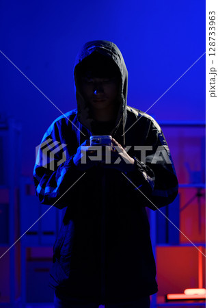 Hacker using smartphone for phishing attack and data theft in dark cyber environment Hacker using smartphone for phishing attack and data theft in dark cyber environment 128733963