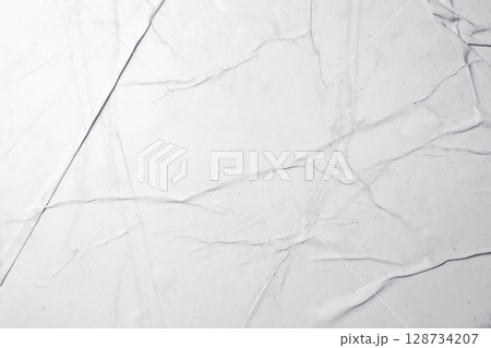 White crumpled paper texture abstract background. Creased and wrinkled paper surface. Copy space White crumpled paper texture abstract background. Creased and wrinkled paper surface. Copy space 128734207