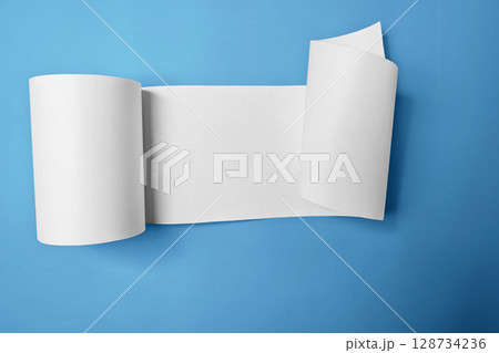 Roll of thermal paper for a receipt on a blue background. Copy space Roll of thermal paper for a receipt on a blue background. Copy space 128734236