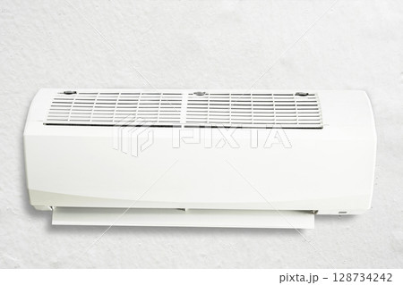 Air conditioner or AC hangs on the wall. Room interior background Air conditioner or AC hangs on the wall. Room interior background 128734242