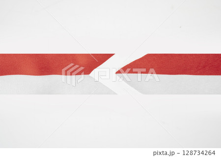 The striped red and white ribbon of the Indonesian flag on a white background. Concept of Indonesian Independence Day or Kemerdekaan 128734264