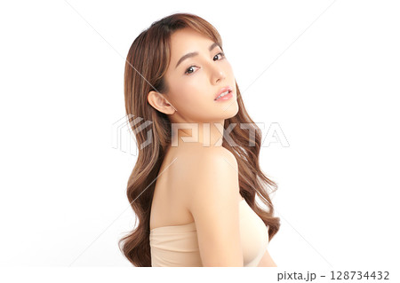 A beautiful young Asian woman with clean, fresh skin against a white background. Skincare, facial treatment, cosmetology, beauty, and spa. An elegant portrait of an Asian woman. A beautiful young Asian woman with clean, fresh skin against a white background. Skincare, facial treatment, cosmetology, beauty, and spa. An elegant portrait of an Asian woman. 128734432
