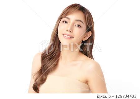A beautiful young Asian woman with clean, fresh skin against a white background. Skincare, facial treatment, cosmetology, beauty, and spa. An elegant portrait of an Asian woman. A beautiful young Asian woman with clean, fresh skin against a white background. Skincare, facial treatment, cosmetology, beauty, and spa. An elegant portrait of an Asian woman. 128734433