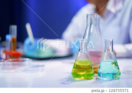 Chemical solutions in glassware during lab experiment Chemical solutions in glassware during lab experiment 128735571