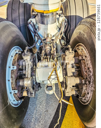 Close-up of aircraft landing gear components and hydraulic brake system parts. High quality photo 128739681