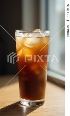 Minimalist Iced Coffee in Sunlit Glass with Melting Ice and Subtle Condensation Detail 128741610