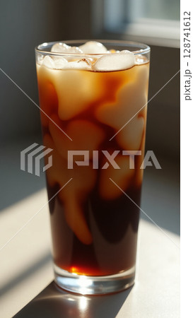 Striking Cream Diffusion in Iced Coffee Under Warm Window Light 128741612