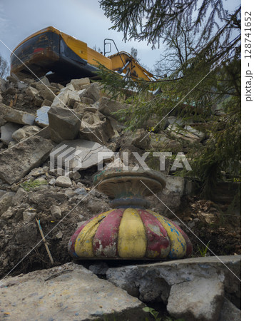 excavator demolishes old soviet architecture with old planter on the ground excavator demolishes old soviet architecture with old planter on the ground 128741652