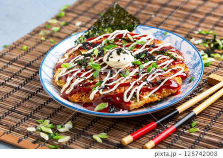 Okonomiyaki - traditional Japanese dish. 128742008