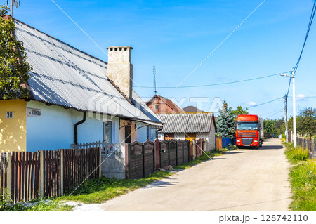 Brest Belarus colorful village streets with wooden huts brick houses . 128742110