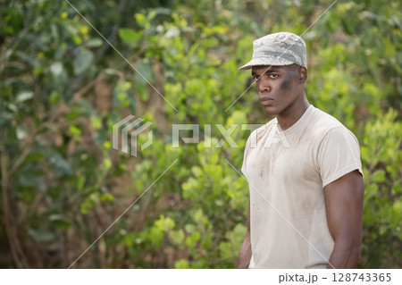 African American man training in woods, wearing camouflage cap and dirty white shirt, copy space African American man training in woods, wearing camouflage cap and dirty white shirt, copy space 128743365