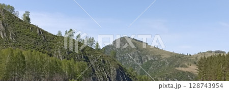 Picturesque Mountain Landscape with Lush Greenery and a Clear Blue Sky Backdrop, Panoramic View 128743954
